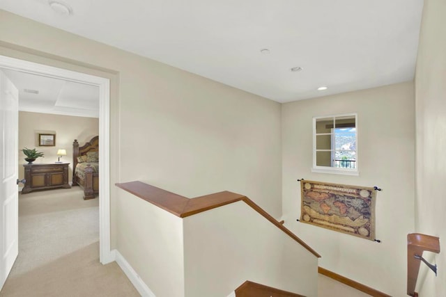 hall featuring recessed lighting, baseboards, carpet, and an upstairs landing