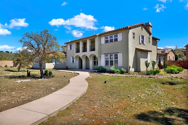 mediterranean / spanish house with stucco siding and fence