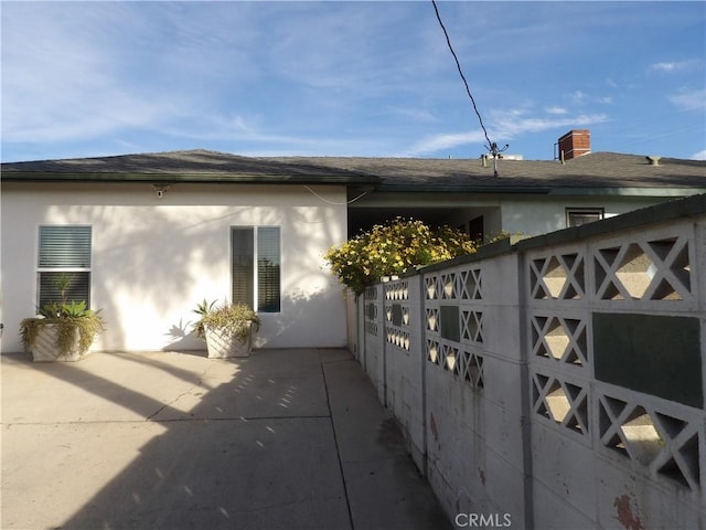 view of side of home featuring stucco siding