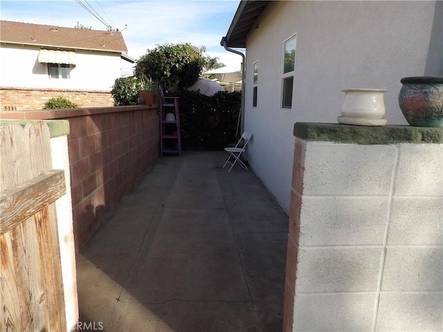 view of side of property featuring a patio and stucco siding