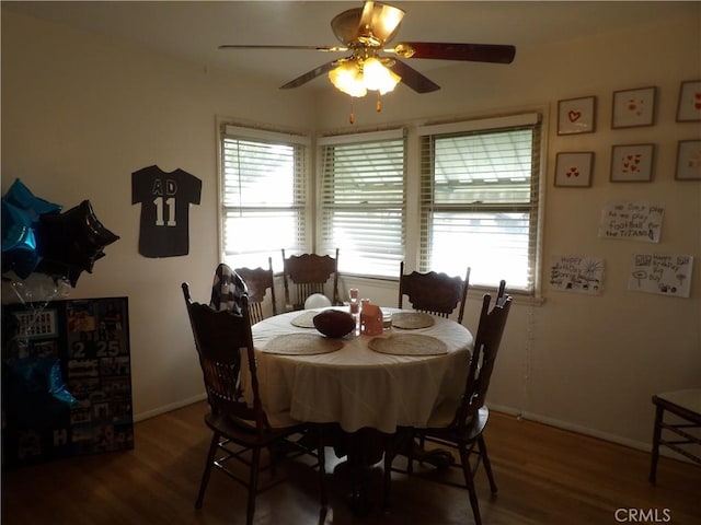dining area featuring plenty of natural light, baseboards, and wood finished floors