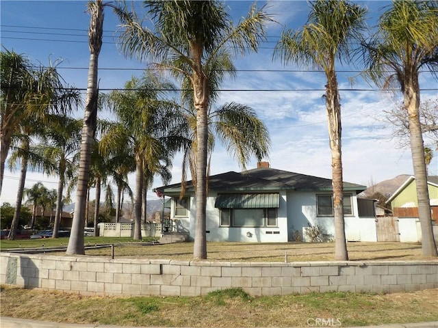 view of front of house with fence and stucco siding