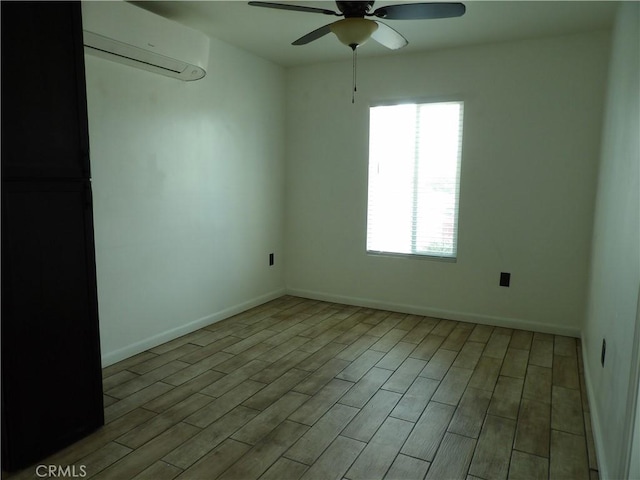 empty room with a ceiling fan, baseboards, a wall mounted AC, and a wealth of natural light