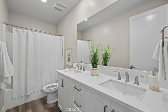 1730 Artemisia Ct, Carlsbad, CA 92011 - bathroom featuring a sink, toilet, wood finished floors, and visible vents