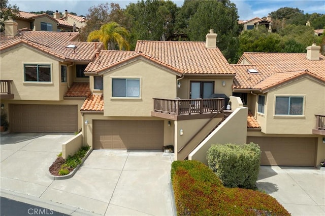 2318 Cranesbill Pl, Avila Beach, CA 93424 - mediterranean / spanish home featuring a garage, a tile roof, concrete driveway, and stucco siding