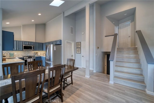 2318 Cranesbill Pl, Avila Beach, CA 93424 - dining space featuring high vaulted ceiling, stairway, light wood-type flooring, and recessed lighting