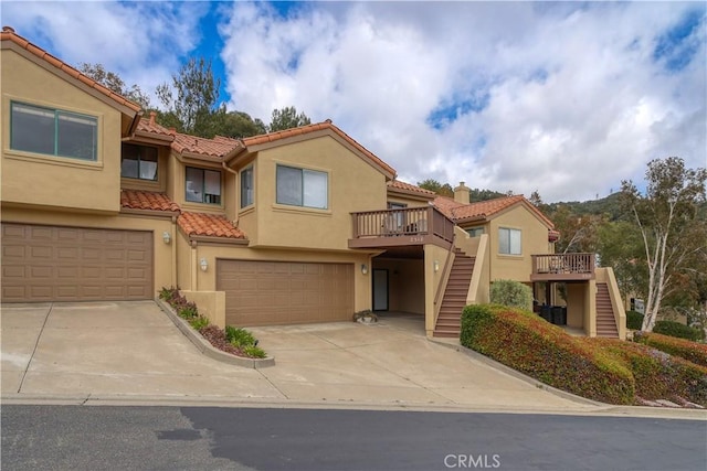 2318 Cranesbill Pl, Avila Beach, CA 93424 - view of front of house featuring stairway, a tile roof, a garage, stucco siding, and concrete driveway