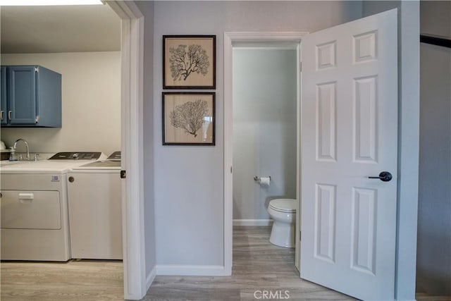 2318 Cranesbill Pl, Avila Beach, CA 93424 - laundry room featuring washer and clothes dryer, light wood-style flooring, and cabinet space