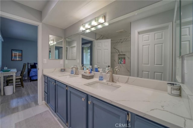 2318 Cranesbill Pl, Avila Beach, CA 93424 - bathroom featuring double vanity, connected bathroom, wood finished floors, and a marble finish shower