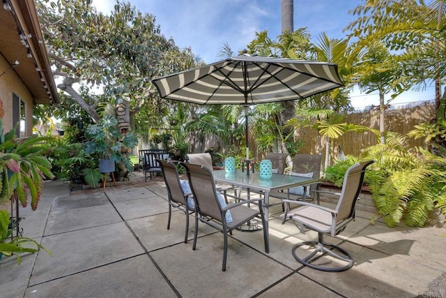 view of patio / terrace featuring fence and outdoor dining area