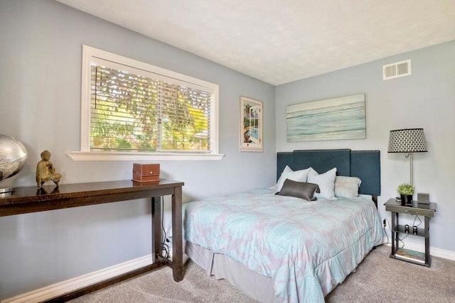 carpeted bedroom featuring visible vents and baseboards
