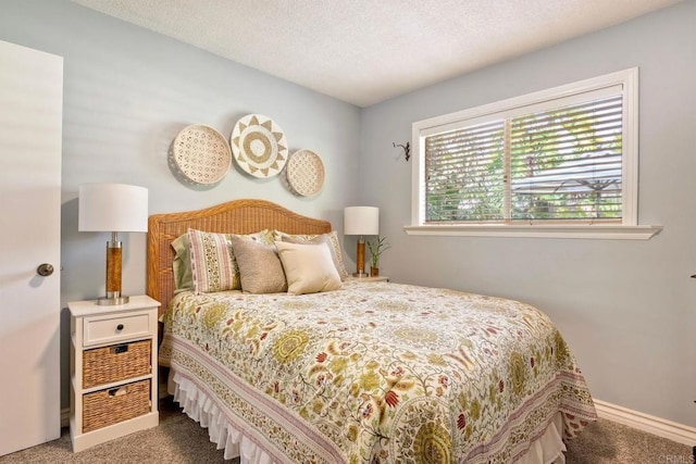 carpeted bedroom featuring baseboards and a textured ceiling