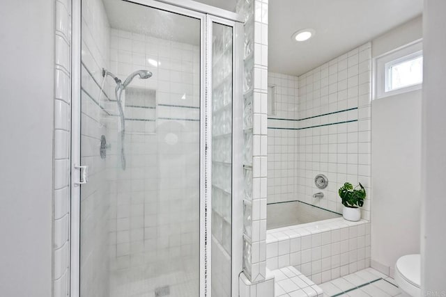 bathroom with toilet and a shower stall