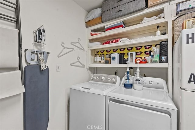 clothes washing area with laundry area and washer and clothes dryer