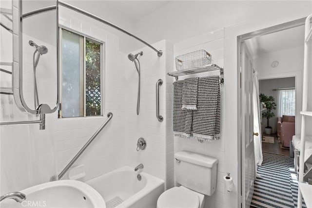 bathroom with a sink, toilet, and washtub / shower combination
