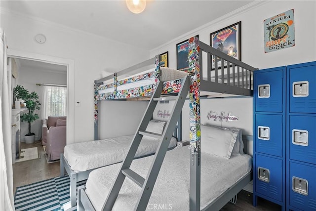 bedroom featuring crown molding and wood finished floors