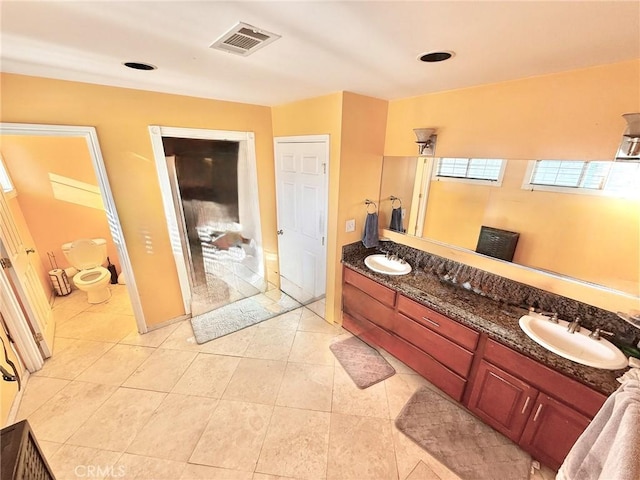full bathroom featuring a sink, double vanity, visible vents, and tile patterned flooring