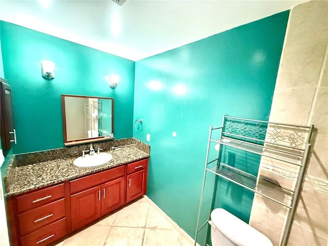 bathroom featuring toilet, vanity, and tile patterned flooring