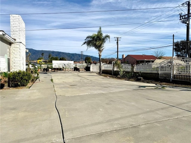 view of patio featuring a mountain view and fence