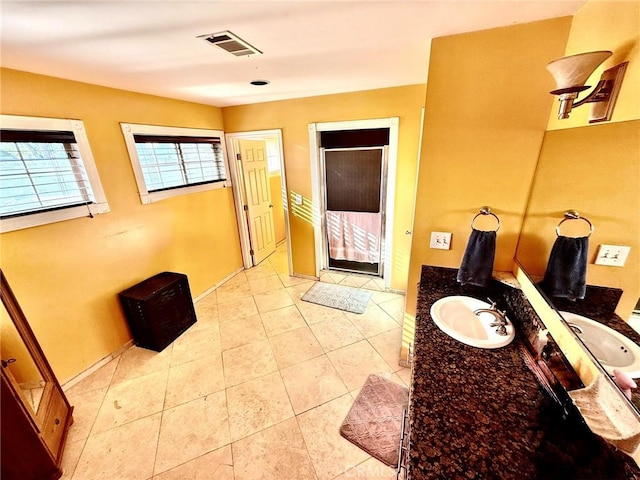 bathroom with a shower stall, visible vents, tile patterned flooring, and vanity