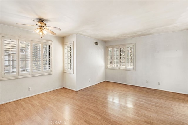 1 Brandy Ln Unit 23, Aliso Viejo, CA 92656 - spare room with healthy amount of natural light, a ceiling fan, wood finished floors, and baseboards