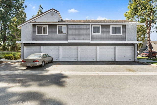 1 Brandy Ln Unit 23, Aliso Viejo, CA 92656 - view of front of home featuring asphalt driveway, an attached garage, and stucco siding