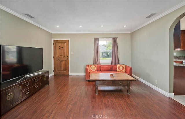 living area featuring crown molding, baseboards, wood finished floors, recessed lighting, and arched walkways