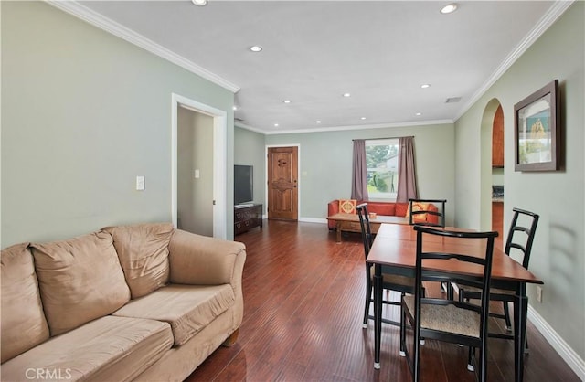 dining area featuring arched walkways, dark wood-type flooring, baseboards, and crown molding