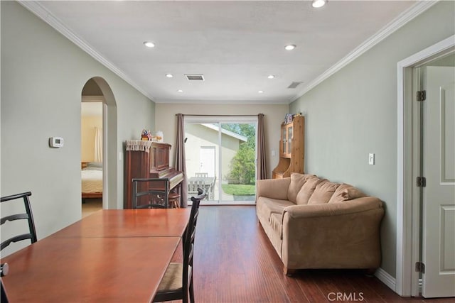 interior space with ornamental molding, dark wood-style flooring, arched walkways, and visible vents