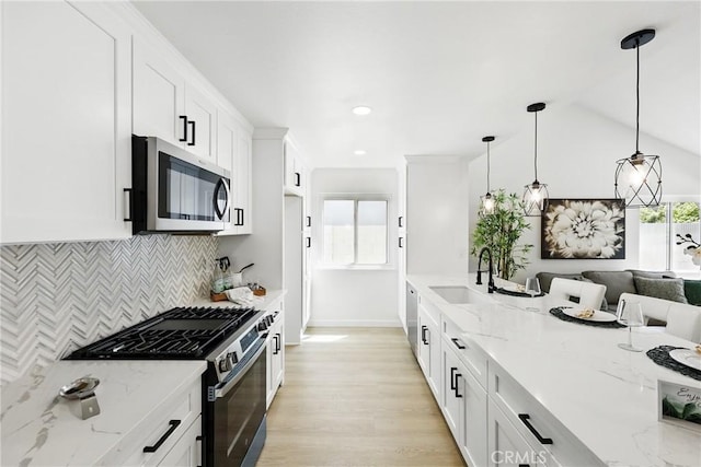 13538 Darvalle St, Cerritos, CA 90703 - kitchen featuring a sink, decorative backsplash, stainless steel appliances, white cabinets, and light stone countertops