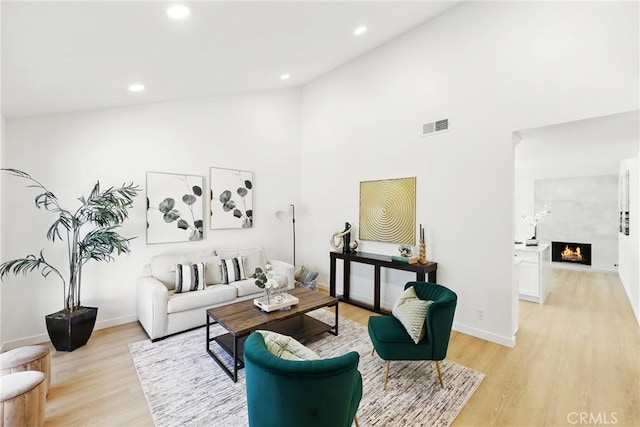 13538 Darvalle St, Cerritos, CA 90703 - living room featuring high vaulted ceiling, light wood-style floors, visible vents, and recessed lighting