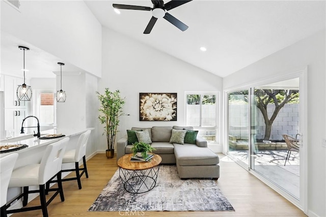 13538 Darvalle St, Cerritos, CA 90703 - living room with high vaulted ceiling, a ceiling fan, light wood-style floors, baseboards, and visible vents