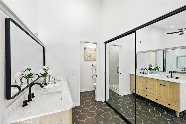 13538 Darvalle St, Cerritos, CA 90703 - full bathroom featuring a sink, double vanity, toilet, a shower stall, and ceiling fan