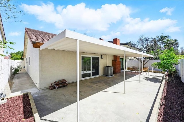 13538 Darvalle St, Cerritos, CA 90703 - rear view of property featuring central AC unit, a fenced backyard, stucco siding, a tile roof, and a patio