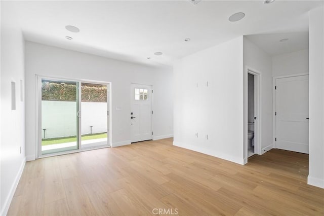 unfurnished living room featuring light wood-style floors and baseboards