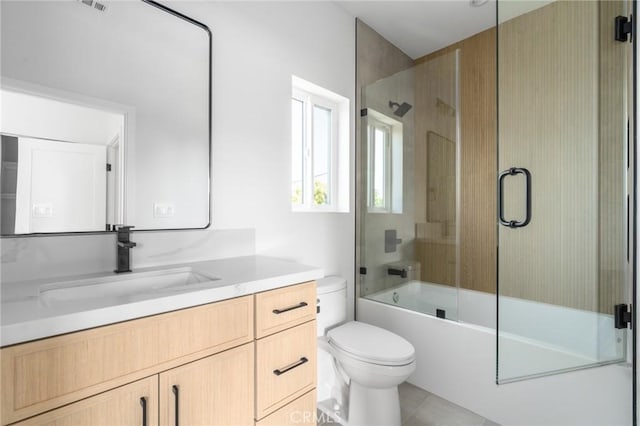 full bathroom with vanity, tile patterned floors, toilet, and shower / bath combination with glass door