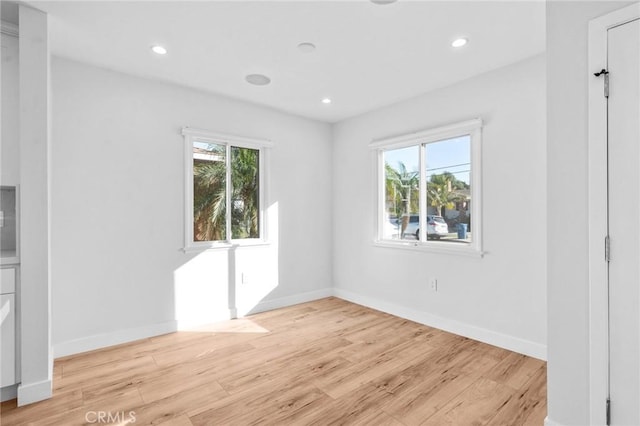 unfurnished room featuring recessed lighting, light wood finished floors, and a healthy amount of sunlight