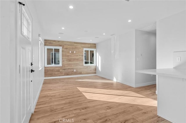 entryway featuring recessed lighting, baseboards, a healthy amount of sunlight, and light wood finished floors