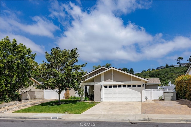 28861 Aloma Ave, Laguna Niguel, CA 92677 - mid-century inspired home featuring stucco siding, a front yard, fence, an attached garage, and driveway
