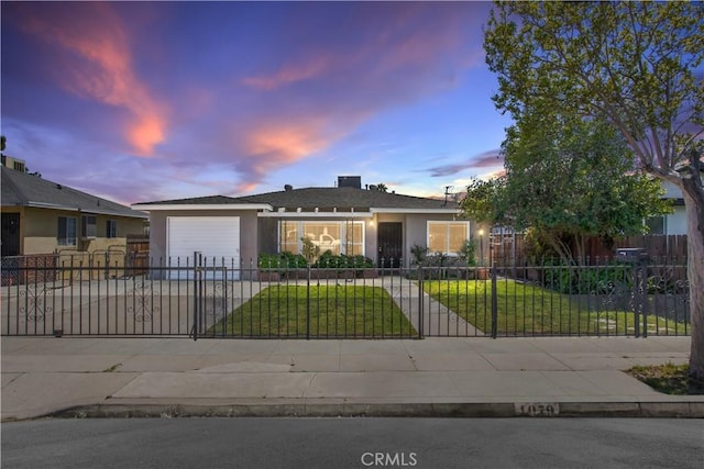 view of front of home featuring a garage, a fenced front yard, concrete driveway, and a lawn