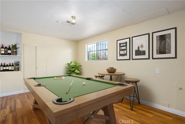 recreation room featuring wood finished floors, baseboards, and visible vents