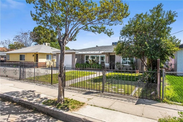 ranch-style house with concrete driveway, a front lawn, an attached garage, and a fenced front yard