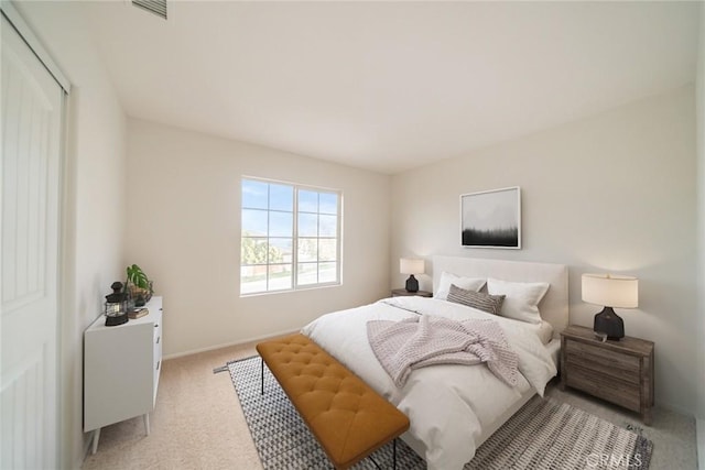 bedroom with visible vents, baseboards, and light colored carpet