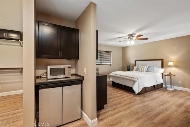 bedroom featuring baseboards, ceiling fan, and light wood finished floors