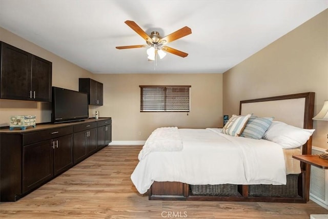 bedroom with baseboards, ceiling fan, and light wood-type flooring