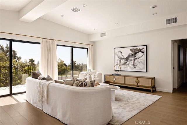living room featuring a healthy amount of sunlight, wood finished floors, and visible vents