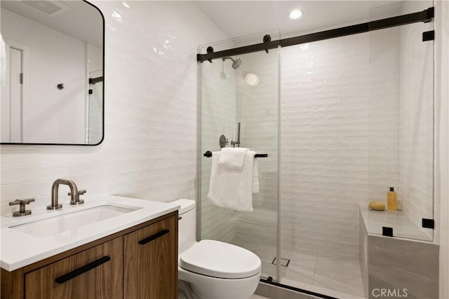 bathroom with vanity, a stall shower, recessed lighting, toilet, and visible vents