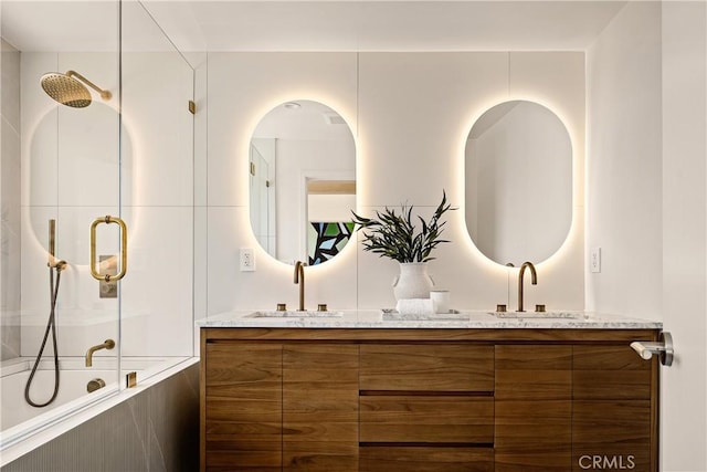 full bath featuring a sink, a bathing tub, double vanity, and a shower with door