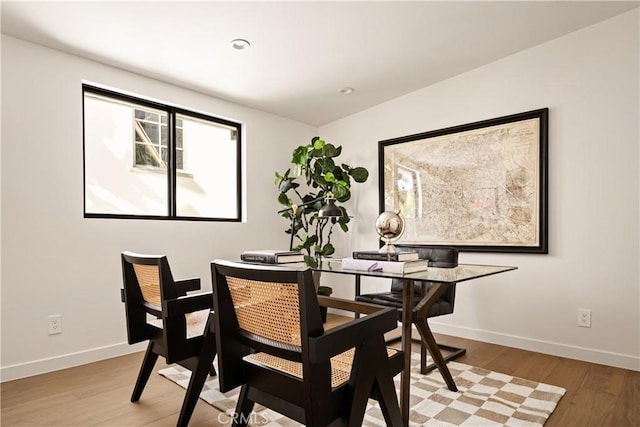 dining room with recessed lighting, light wood-style flooring, and baseboards