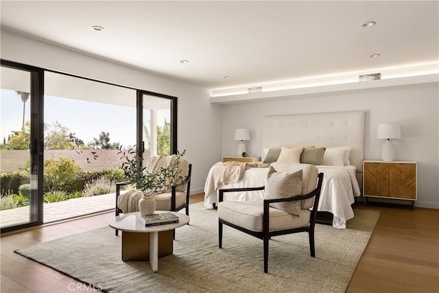 bedroom featuring access to outside, visible vents, recessed lighting, wood finished floors, and baseboards